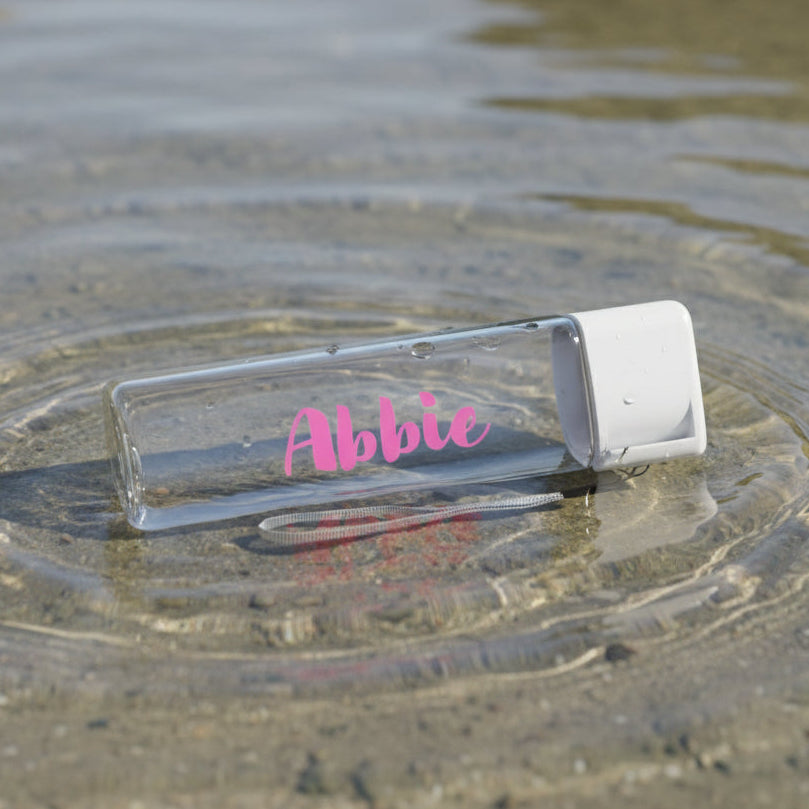 Clear water bottle with 'Abbie' branding, featuring product size, material quality, ease of carrying, and color options on a light background.
