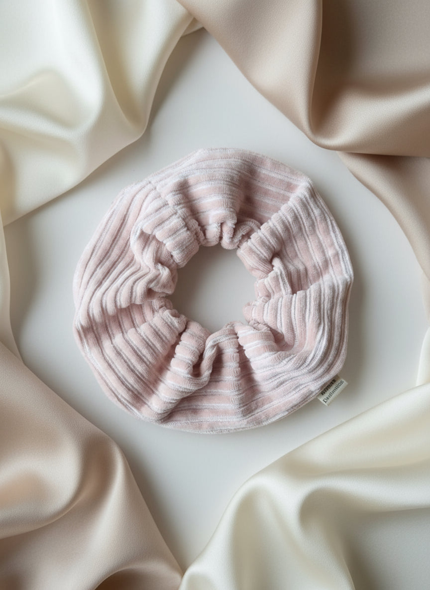 Handmade chunky cordury scrunchie handmade by Aurora's Destination. Soft cord fabric, with an elastic middle to ensure it stays safely put in your hair. Scrunchie is placed on a soft neutral background surrounded by beige silks. Hair accessory also includes a custom organic cotton Aurora's Destination tag sewn into the seam. Taking the brand everywhere the hair band goes. 